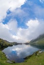 Balea lake and Balea Hotel in spring time with clouds Royalty Free Stock Photo